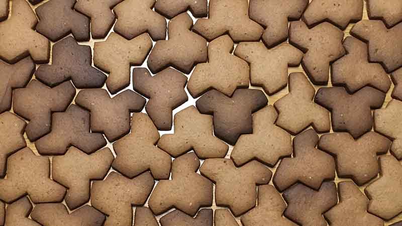 Cookies cut in the Einstein tile shape, forming a tiling.