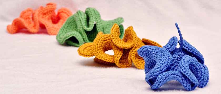 Four small hyperbolic crochet models in different colors